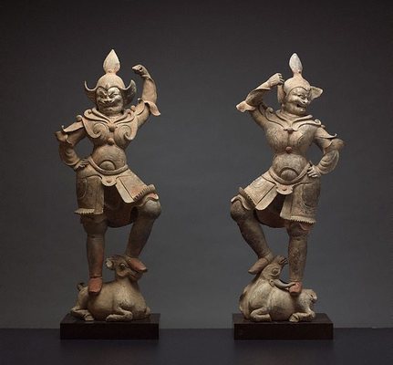 A pair of tomb guardian figures A pair of tomb guardian figures